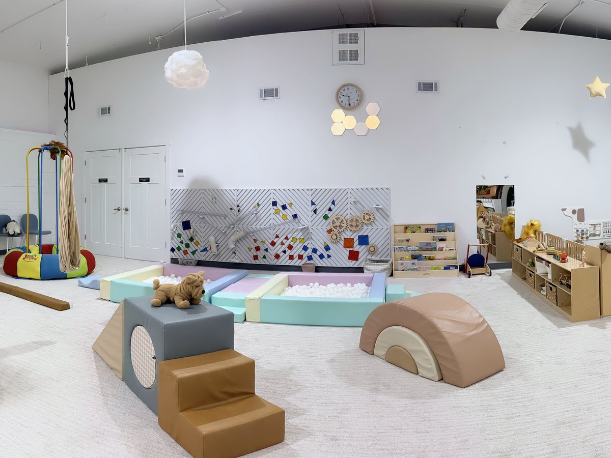 The Enchanted Sky main playroom with soft play shapes and wooden climbers