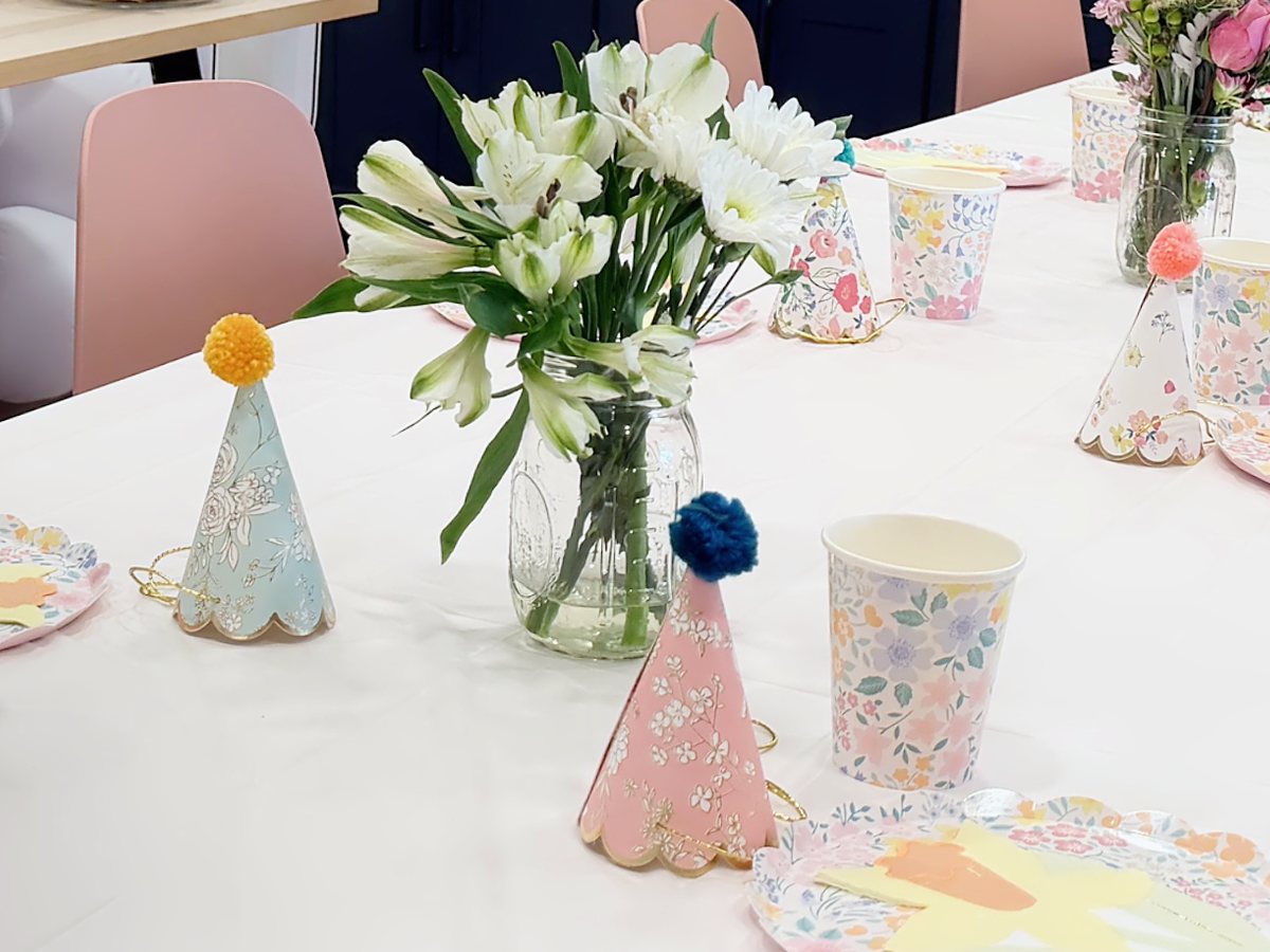 Party table set with party hats, cups and plates